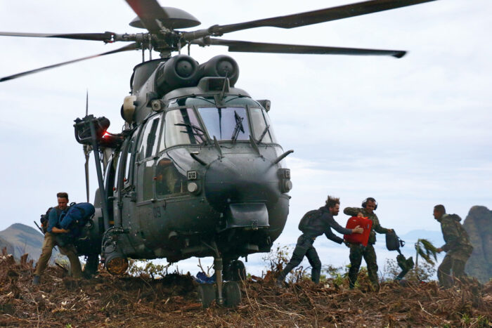 An army helicopter transported scientists and equipment to the top of the mountain range